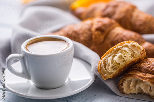 Fresh buttery croissants with coffee. Sweet morning breakfast concept.