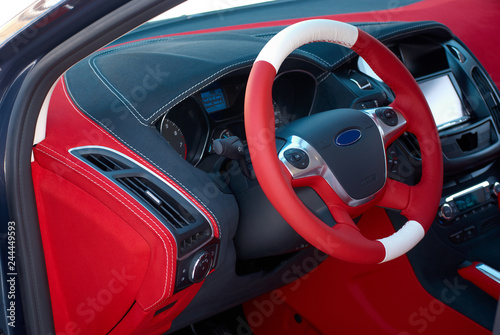 Car dashboard. Car interior details. Red and black alcantara with stitching