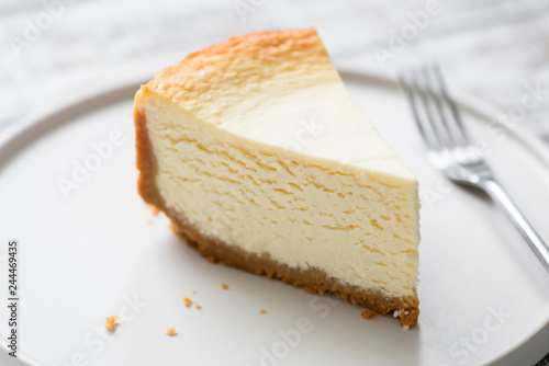 New York Cheesecake Slice On Plate. Closeup view. Tasty smooth cheesecake