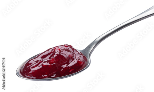 Spoon of red jam isolated on white background