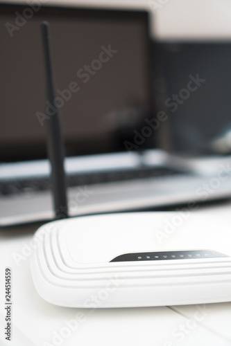 White wireless router standing on the table.