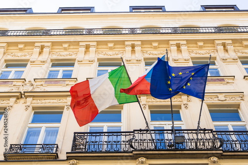 italian and european flags and other flag on a balcony