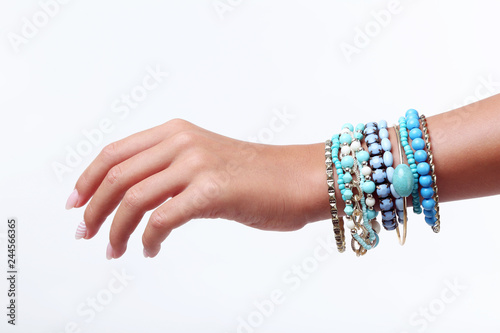 Female hand with bracelets on white background
