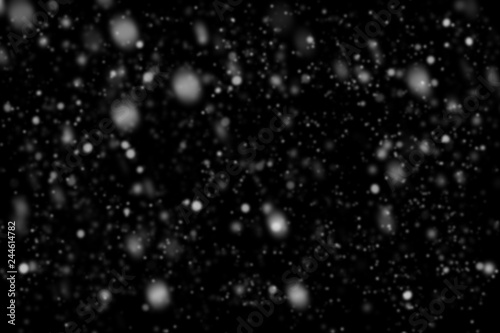 Snowfall on black background. Snow bokeh texture