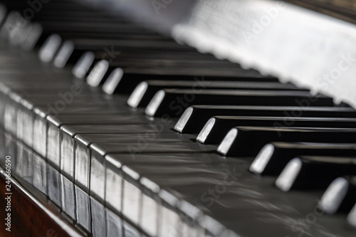 Antique piano keys and wood grain. Closeup, selective focus
