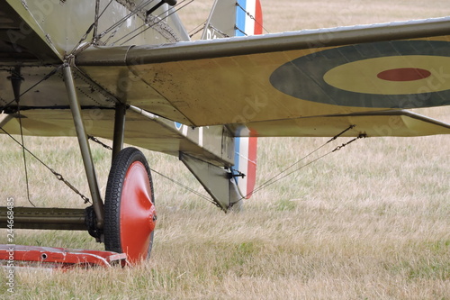 A wheel and a wing of a biplane bomber