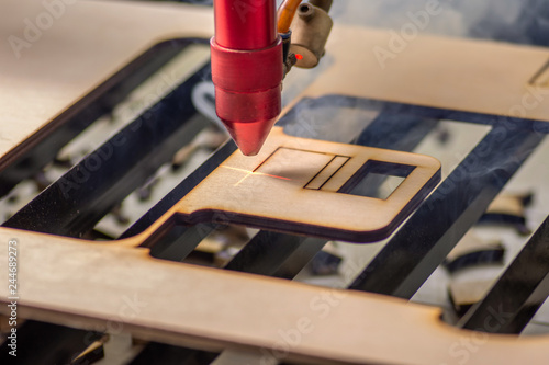 Laser engraver working and engraving wooden board