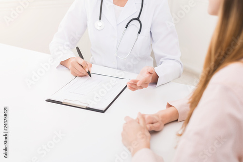 Doctor writing in clipboard patient's anamnesis, copy space