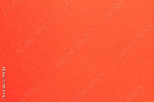 The background color of the trend. Red abstract geometric background. The texture of colored cardboard.