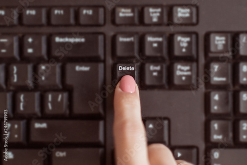 Woman presses the delete key.