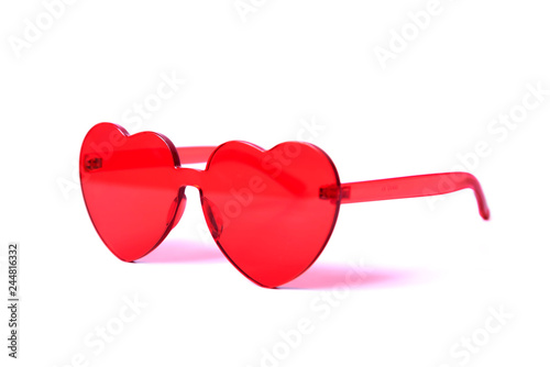 Stylish red heart-shaped sunglasses isolated on white background