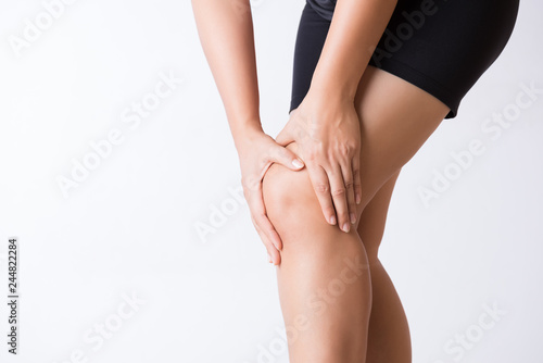 Runner sport knee injury. Closeup young woman in knee pain while running. Healthcare and medical concept.