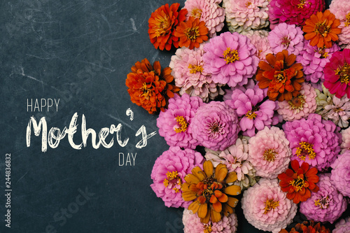 Zinnia flowers in group with Mother's Day text on chalkboard background for holiday graphic.