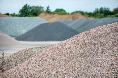 Large piles of construction sand and gravel used for asphalt production and building. Limestone quarry, mining rocks and stones 