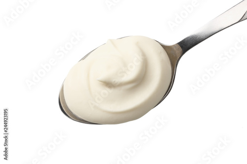 sour cream in spoon isolated on white background