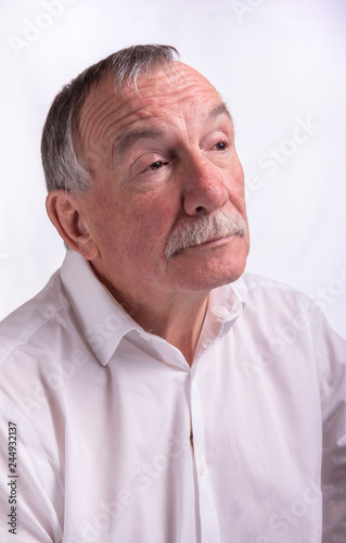 Vertical high key portrait of senior man 