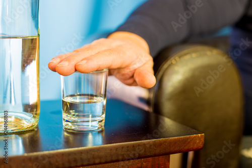 a man refuses to drink a glass of brandy