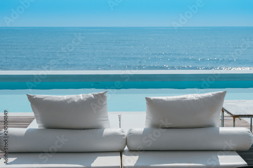 luxury swimming pool on sea view and beach chair in hotel resort