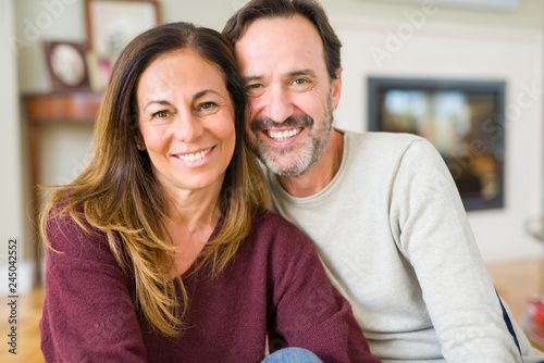 Beautiful romantic couple sitting together on the floor at home