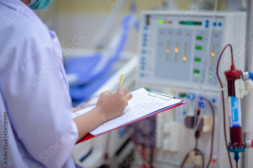 Dialysis nurse are checking dialysis machine before hemodialysis replacement kidney dysfunction or renal failure in intensive care unit.