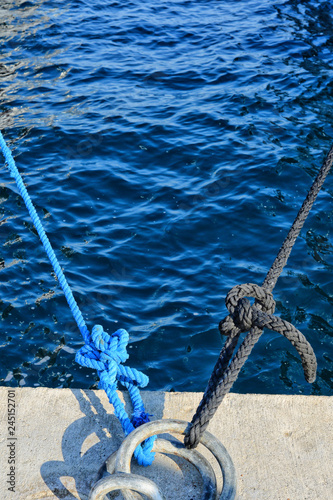 Bollard roped tied on the dock close up view