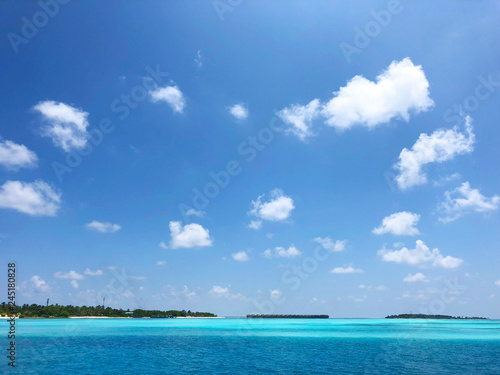 tropical island profile with blue water and cloudy sky