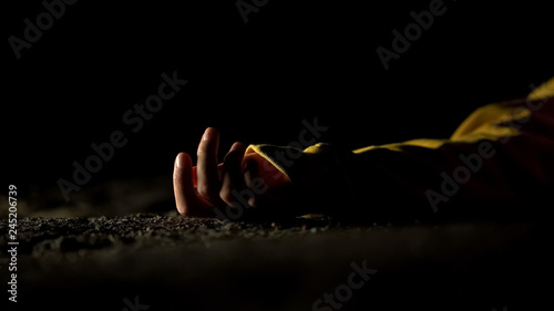 Unconscious victim lying on asphalt, automobile driving after road accident