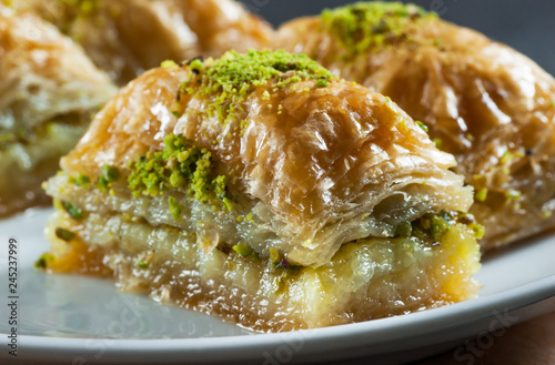 Traditional turkish dessert antep baklava with pistachio on white plate. Desserts concept