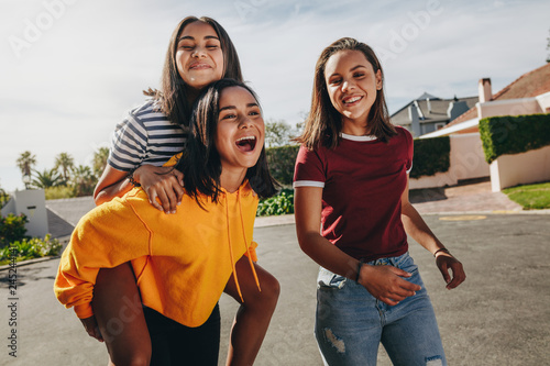 Girl friends walking in the street having fun