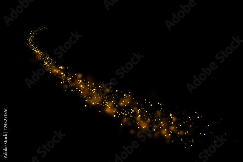 Gold glitter particles lights trail and bokeh on a black background. Abstract line sparkle texture.
