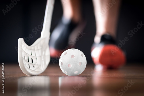 Floorball player running with ball and stick. Floor hockey concept.