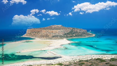 Balos lagoon on Crete island, Greece. Tourists relax and bath in crystal clear water of Balos beach.