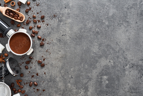 Top view of coffee background. Assorted coffee beans, ground coffee, portafilter and tamper on dark concrete background. Flat lay. Copy space for text. Barista concept.