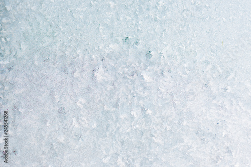 Winter background with gleaming ice. Frozen water texture. Copy space.
