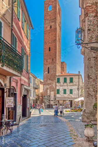 Old medieval tower in a square in Noli, Italy