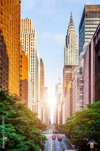 42nd street, Manhattan viewed from Tudor City Overpass with Chrysler Building in background in New York City during sunny summer daytime at sunset