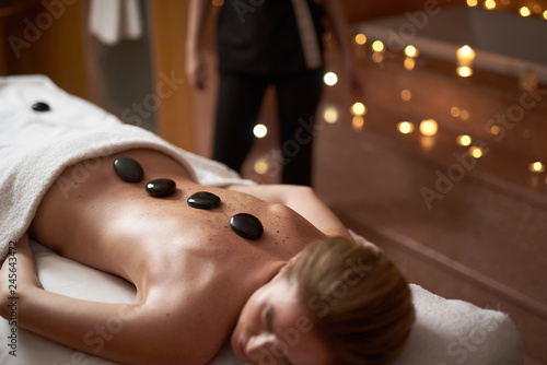 Lady have relieving massage with warm stones