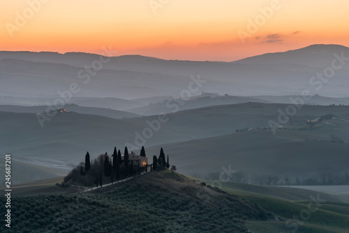 The beauty of the Tuscan hills of the Val d'Orcia at the first light of dawn, Siena, Tuscany, Italy