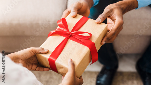 Birthday present. Father giving gift to daughter