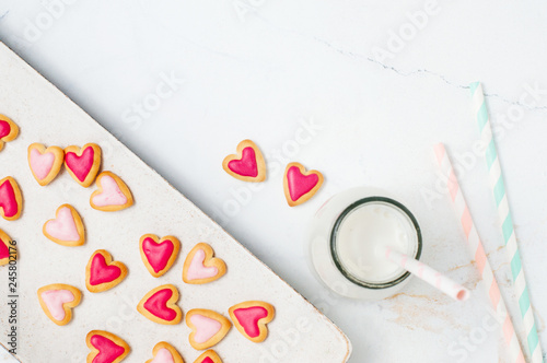 Cookies for Valentines Day and milkshake on light marble background