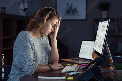Stressed woman working over time at night