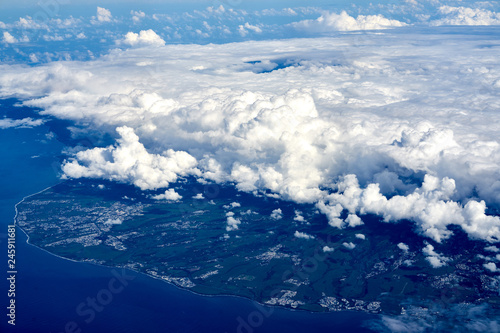 Reunion island covered by a mricroclimate cloud system. The island as seen on a flight from South Africa to Mauritius