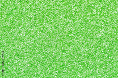 Green foam sponge closeup pattern texture.