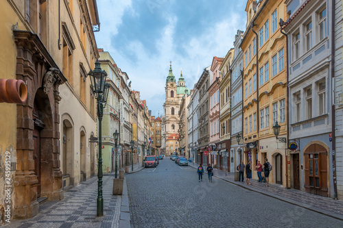 Prague, Czech Republic - August 25 2018: Early morning picture of Czech street in downtown Prague with tourists