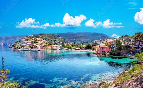 Beautiful landscape with bay and colorful buildings on the background of picturesque clouds in the town of Asos, Greece, Kefalonia. Wonderful exciting places.