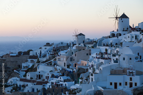 View of Oia Village with windmills at sunset, Santorini Greece