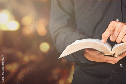 Man reading old heavy book on background