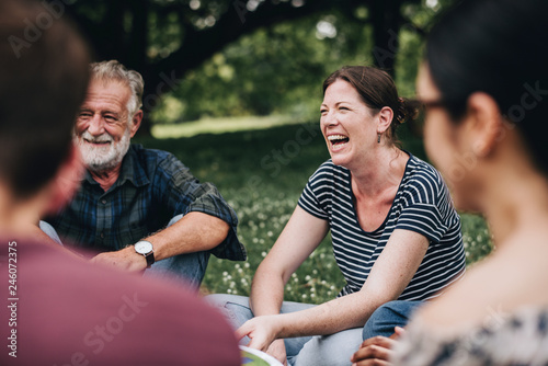 Cheerful woman in the park with her friends