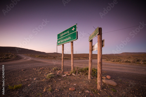 Wide angle view of roadsigns on a dirtroad, in the karoo region of south africa, showing the direction to the towns of Sutherland and Laingsburg