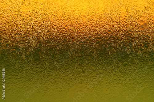 Artistic condensation on vibrant orange and green color glass bottle 